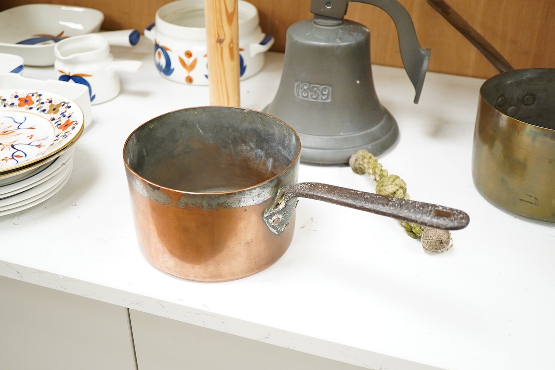 A bronze bell dated 1839 and two Victorian copper and brass saucepans